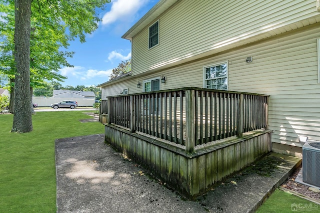 deck featuring a yard and central air condition unit