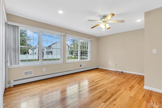 empty room featuring ceiling fan, recessed lighting, baseboards, baseboard heating, and light wood finished floors