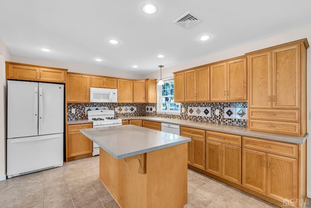 kitchen with a center island, pendant lighting, visible vents, backsplash, and white appliances