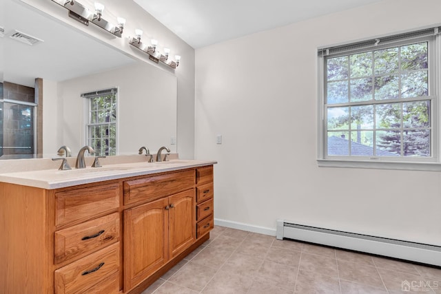 bathroom with a baseboard heating unit, visible vents, baseboards, a shower stall, and double vanity