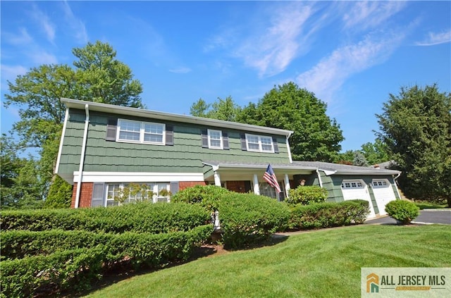 20 Rath Ln, East Brunswick, NJ 08816 - view of front of property with a front yard, a garage, and brick siding