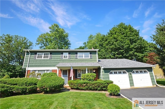 20 Rath Ln, East Brunswick, NJ 08816 - traditional home with an attached garage, driveway, and a front lawn