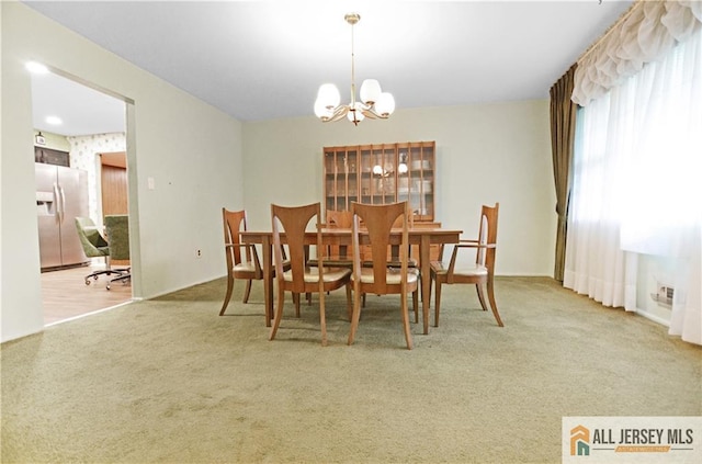 20 Rath Ln, East Brunswick, NJ 08816 - carpeted dining area with a chandelier