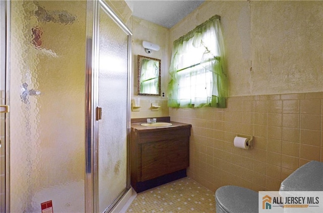20 Rath Ln, East Brunswick, NJ 08816 - bathroom featuring a shower stall, vanity, tile walls, and tile patterned floors