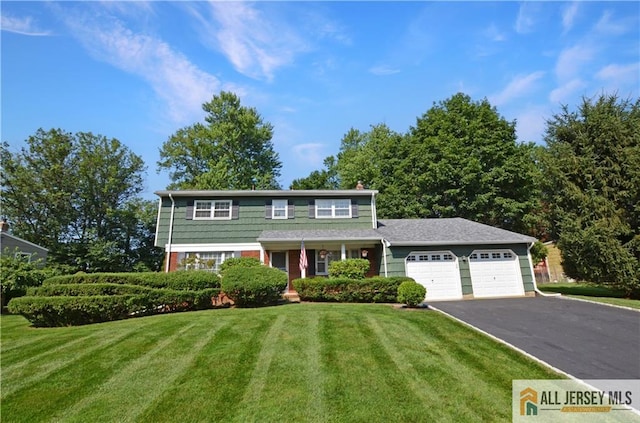 20 Rath Ln, East Brunswick, NJ 08816 - view of front facade featuring driveway, a front yard, and a garage