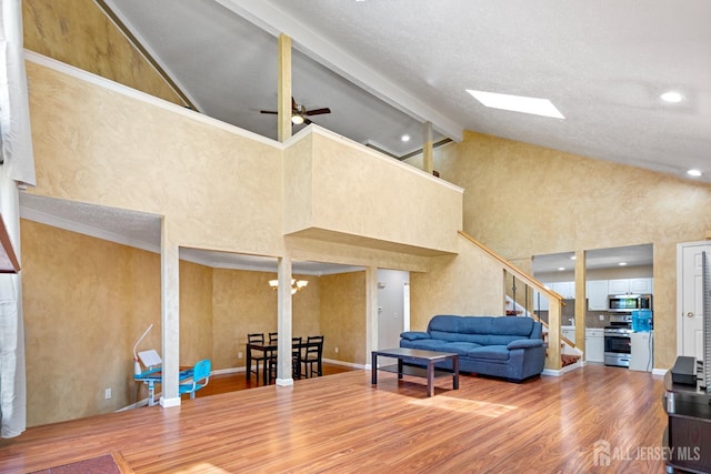 12 Arbor Ct, South Brunswick, NJ 08852 - living room with wood finished floors, high vaulted ceiling, ceiling fan, beam ceiling, and stairway
