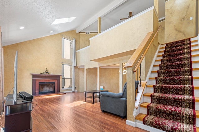 12 Arbor Ct, South Brunswick, NJ 08852 - living area featuring a skylight, wood finished floors, stairs, a fireplace, and beam ceiling