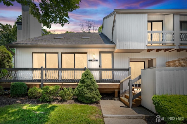 12 Arbor Ct, South Brunswick, NJ 08852 - rear view of house featuring roof with shingles, a chimney, and a deck
