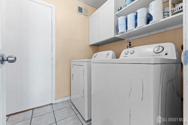 12 Arbor Ct, South Brunswick, NJ 08852 - laundry area featuring cabinet space, separate washer and dryer, and light tile patterned flooring