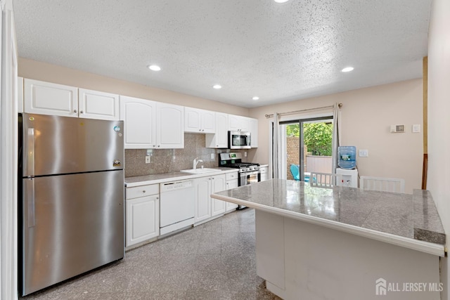 12 Arbor Ct, South Brunswick, NJ 08852 - kitchen with appliances with stainless steel finishes, tile counters, white cabinetry, recessed lighting, and granite tiled floors