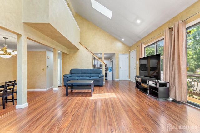 12 Arbor Ct, South Brunswick, NJ 08852 - living room with wood finished floors, high vaulted ceiling, and a chandelier