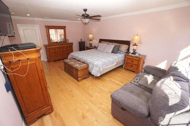 bedroom featuring ceiling fan, light wood-style flooring, and ornamental molding