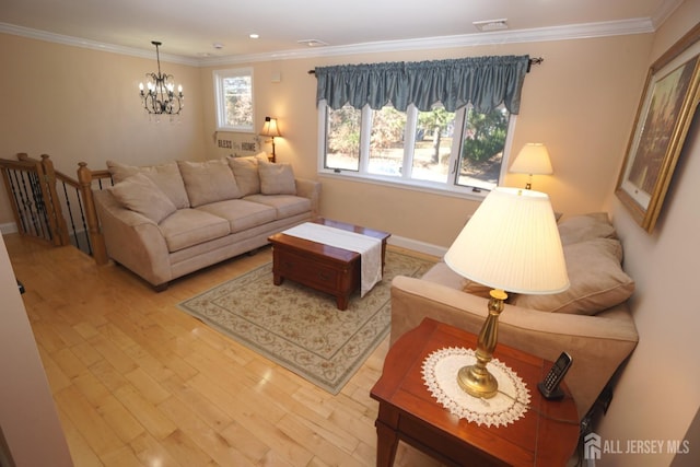 living room featuring visible vents, wood finished floors, an inviting chandelier, crown molding, and baseboards