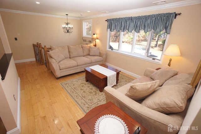 living area featuring visible vents, ornamental molding, light wood-style floors, an inviting chandelier, and baseboards