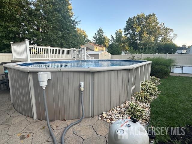 view of swimming pool with a fenced in pool and fence