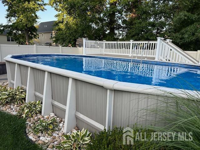 view of swimming pool featuring a fenced in pool and fence