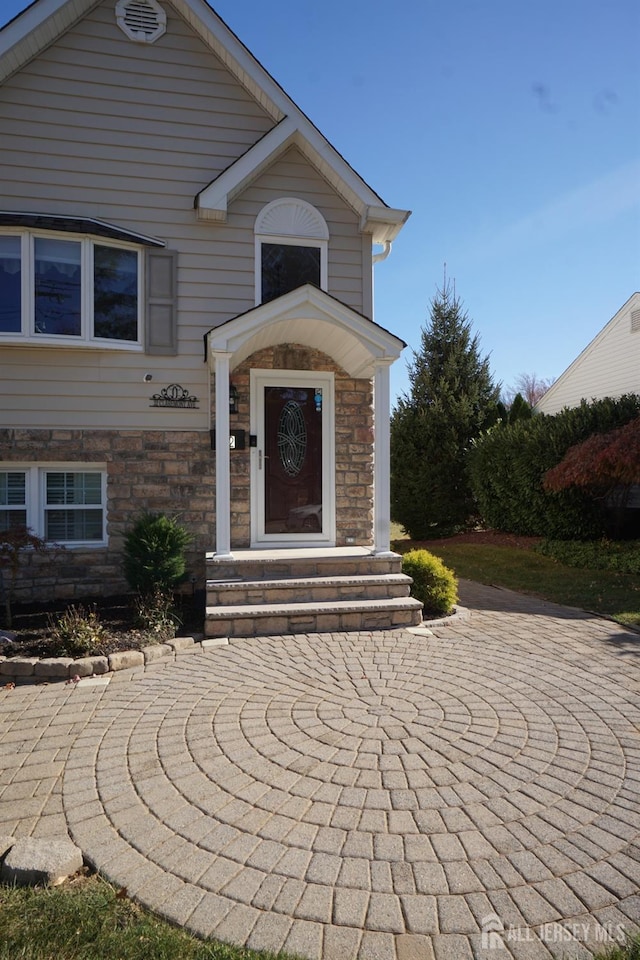 doorway to property featuring stone siding