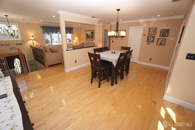 dining space with light wood-style flooring, recessed lighting, crown molding, baseboards, and a chandelier