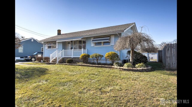 view of front of home with a porch and a front lawn