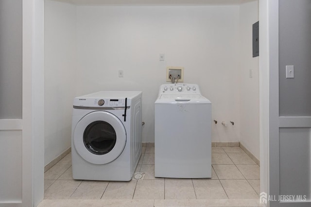 15 Pennyroyal Ct, South Brunswick, NJ 08540 - laundry area with washer and dryer, light tile patterned floors, and electric panel