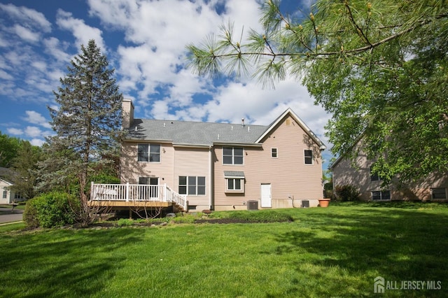 15 Pennyroyal Ct, South Brunswick, NJ 08540 - rear view of property featuring a lawn, a wooden deck, a chimney, and central AC