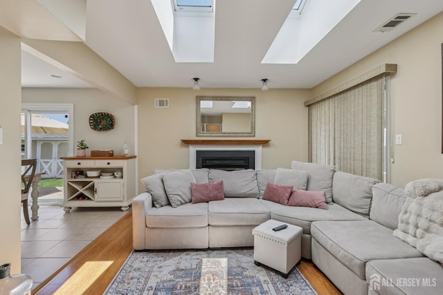 6 E Wintergreen Ave, Edison, NJ 08820 - living area featuring a skylight, a fireplace, and wood finished floors