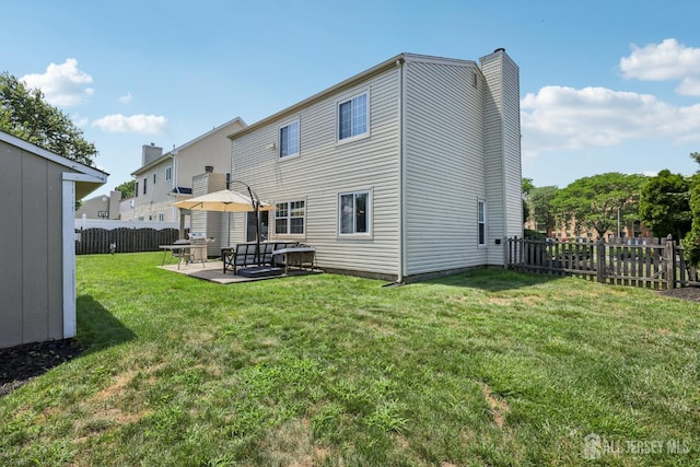 6 E Wintergreen Ave, Edison, NJ 08820 - rear view of property with a chimney, a fenced backyard, a patio area, and an outdoor living space
