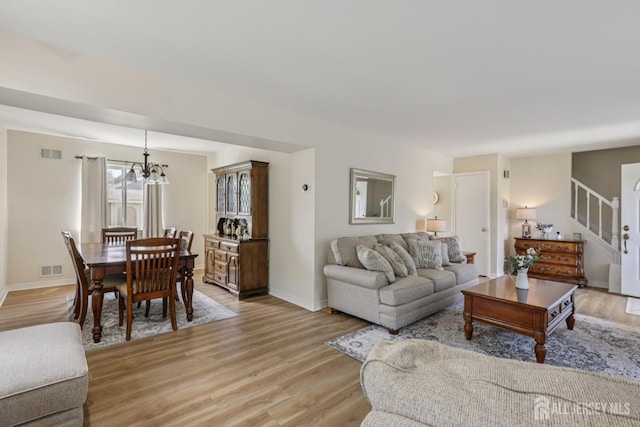 6 E Wintergreen Ave, Edison, NJ 08820 - living area with a chandelier, light wood-type flooring, and stairs