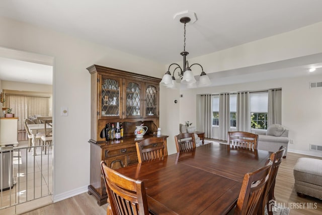 6 E Wintergreen Ave, Edison, NJ 08820 - dining area with a chandelier and light wood-style flooring