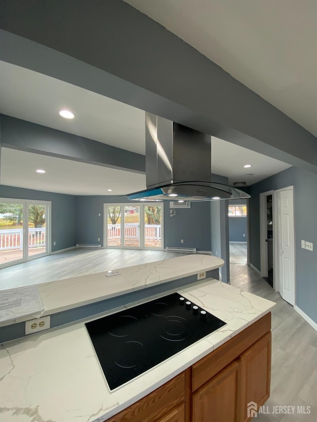 kitchen featuring light hardwood / wood-style flooring, black electric stovetop, plenty of natural light, and island exhaust hood