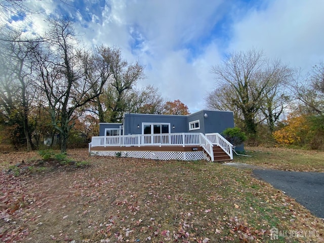 view of front facade with a wooden deck