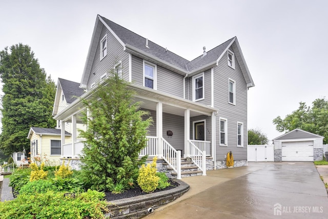 382 Highland St, South Amboy, NJ 08879 - view of front of home featuring a detached garage, covered porch, and an outdoor structure