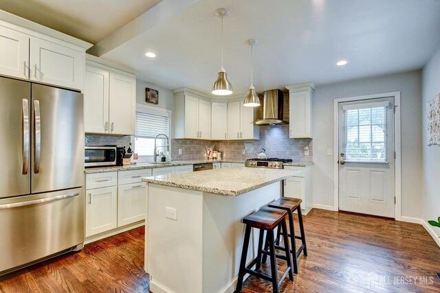382 Highland St, South Amboy, NJ 08879 - kitchen featuring appliances with stainless steel finishes, wall chimney exhaust hood, backsplash, dark wood-type flooring, and recessed lighting
