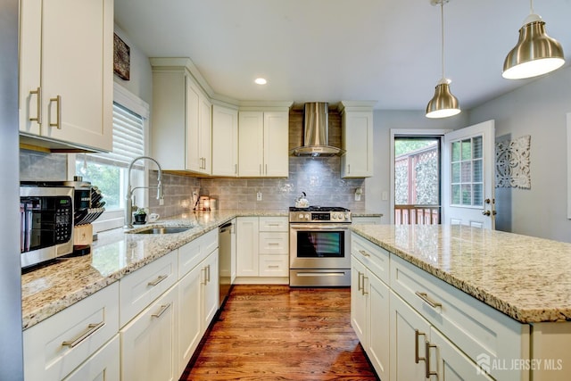 382 Highland St, South Amboy, NJ 08879 - kitchen with appliances with stainless steel finishes, wall chimney exhaust hood, decorative backsplash, recessed lighting, and dark wood-style flooring
