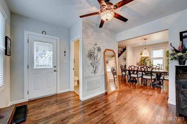 382 Highland St, South Amboy, NJ 08879 - foyer featuring wood finished floors, a ceiling fan, and arched walkways