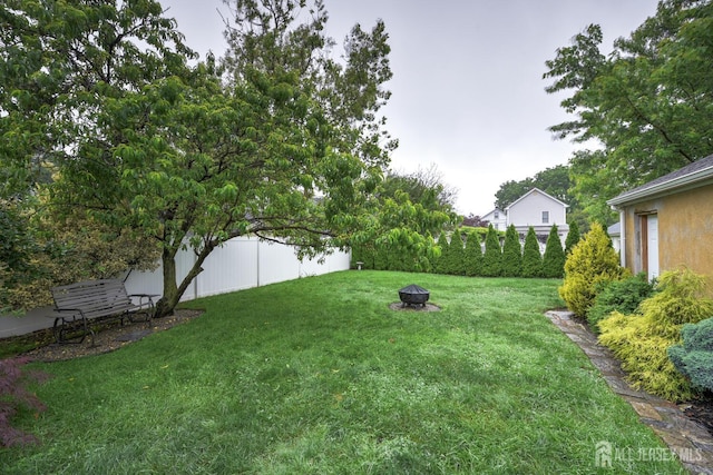 382 Highland St, South Amboy, NJ 08879 - view of green lawn with an outdoor fire pit