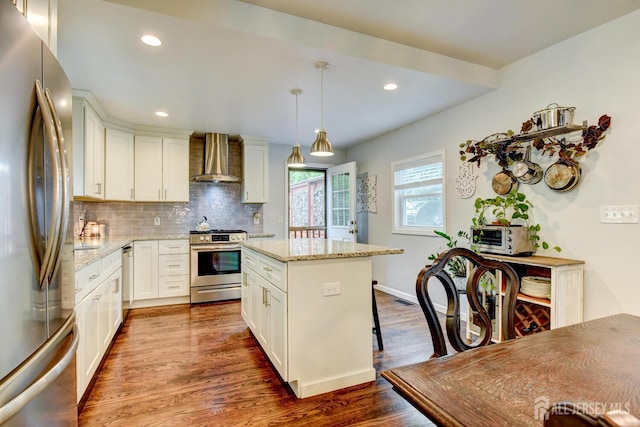 382 Highland St, South Amboy, NJ 08879 - kitchen featuring appliances with stainless steel finishes, wall chimney range hood, dark wood-type flooring, tasteful backsplash, and light stone counters