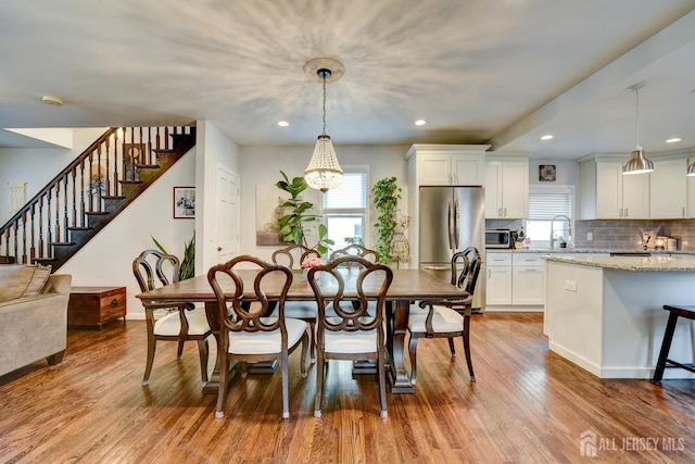 382 Highland St, South Amboy, NJ 08879 - dining space with stairs, recessed lighting, wood finished floors, and a chandelier
