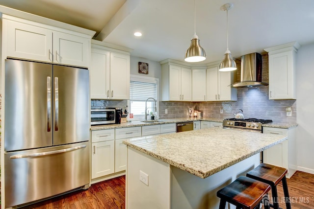 382 Highland St, South Amboy, NJ 08879 - kitchen with appliances with stainless steel finishes, wall chimney exhaust hood, a breakfast bar, dark wood-style floors, and recessed lighting