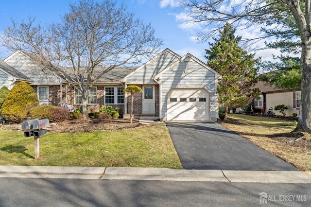 view of front of home with a front lawn and a garage