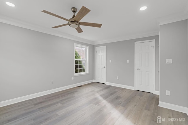 empty room with ceiling fan, light hardwood / wood-style flooring, and ornamental molding