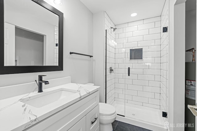 bathroom with walk in shower, tile patterned floors, vanity, and toilet