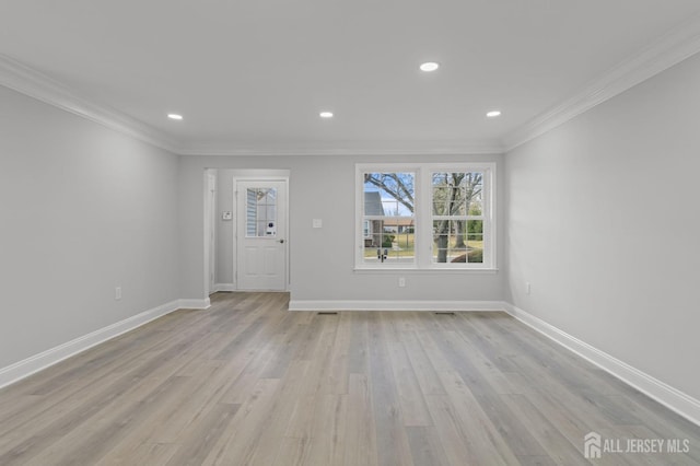 unfurnished room with light hardwood / wood-style flooring and ornamental molding