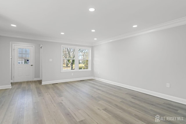 unfurnished living room with light hardwood / wood-style floors and ornamental molding