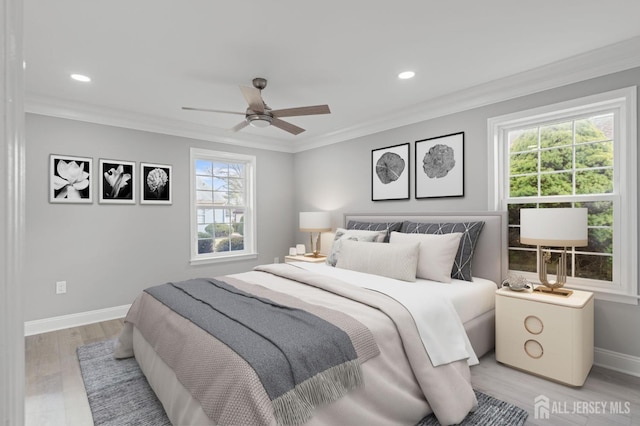 bedroom featuring multiple windows, ceiling fan, crown molding, and light wood-type flooring