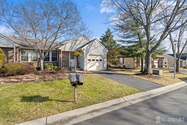 view of front of home featuring a garage and a front lawn