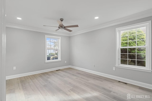 empty room with ceiling fan, light hardwood / wood-style flooring, a healthy amount of sunlight, and ornamental molding