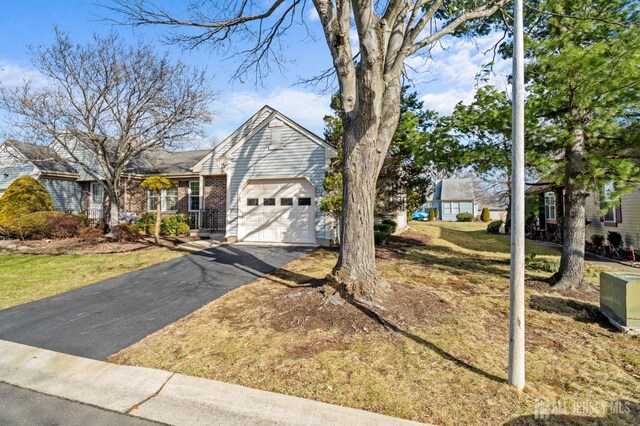 ranch-style home with a front yard and a garage