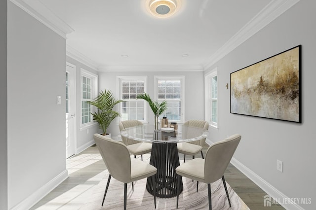 dining room featuring light hardwood / wood-style floors and ornamental molding