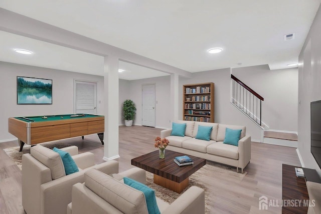 living area featuring baseboards, visible vents, and light wood-style flooring